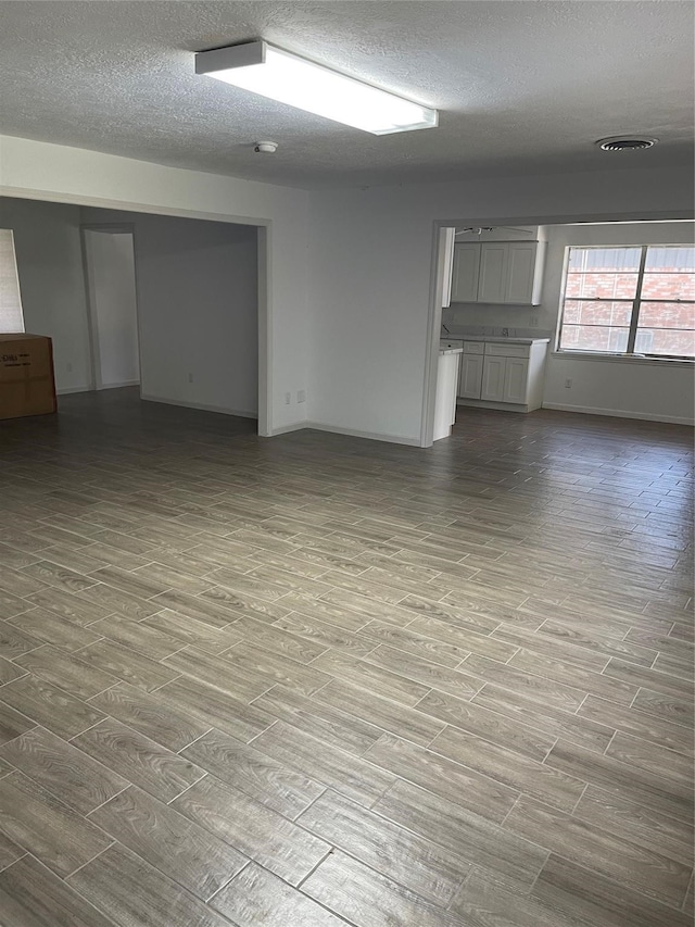 interior space featuring a textured ceiling and light hardwood / wood-style flooring