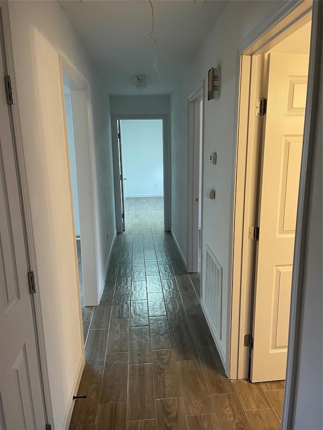 hallway with dark hardwood / wood-style flooring