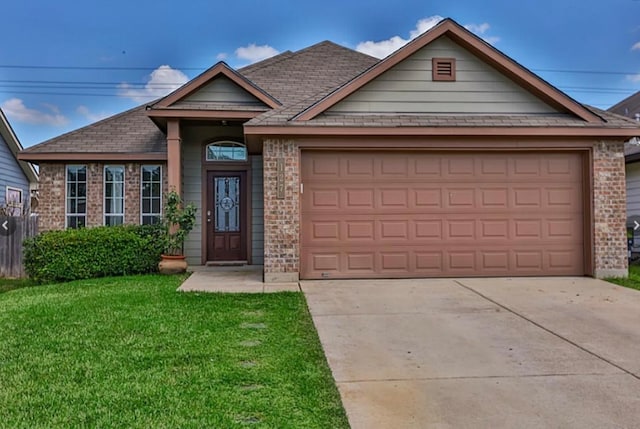 view of front of property featuring a garage and a front lawn