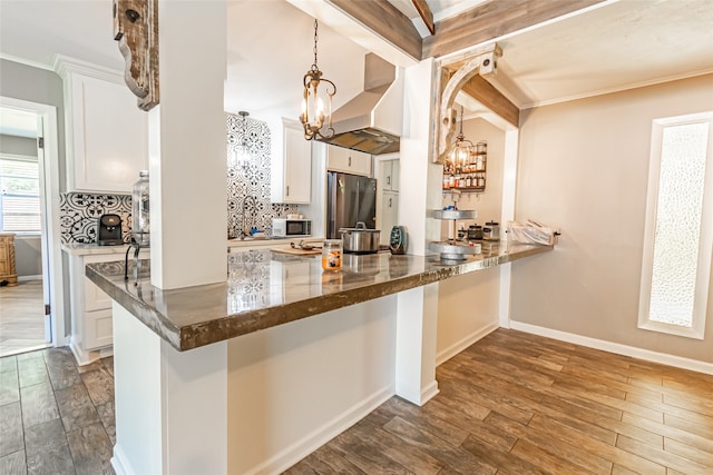 kitchen featuring beam ceiling, decorative light fixtures, white cabinets, stainless steel fridge, and dark wood-type flooring