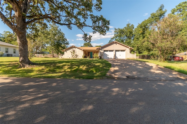 single story home featuring a garage and a front yard