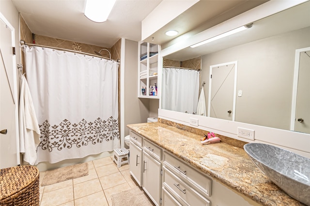 bathroom featuring tile patterned flooring, vanity, and toilet