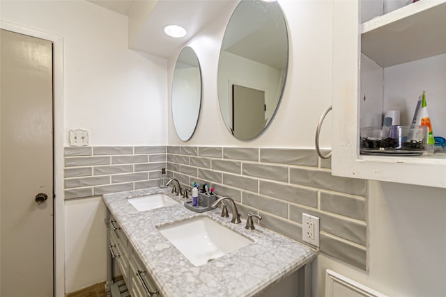 bathroom featuring vanity and decorative backsplash