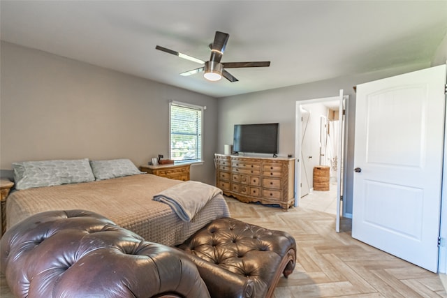 bedroom with light parquet flooring, ensuite bathroom, and ceiling fan