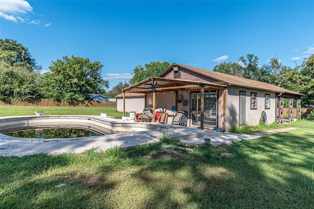 rear view of house featuring a yard and a patio area