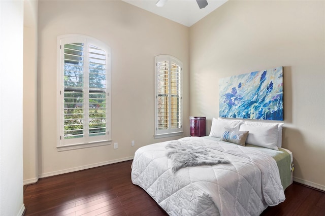 bedroom with dark hardwood / wood-style flooring and ceiling fan