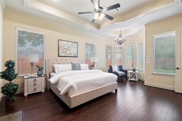 bedroom featuring dark hardwood / wood-style flooring, a tray ceiling, and ornamental molding