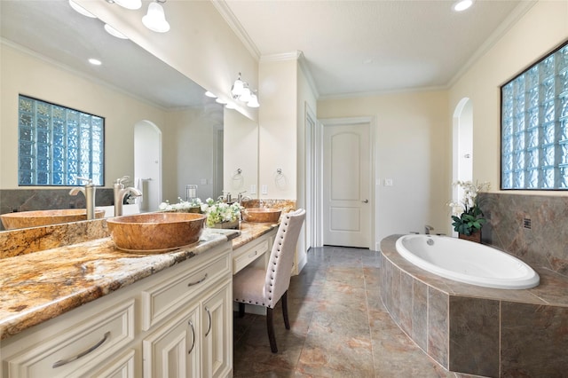 bathroom with crown molding, tiled bath, and vanity