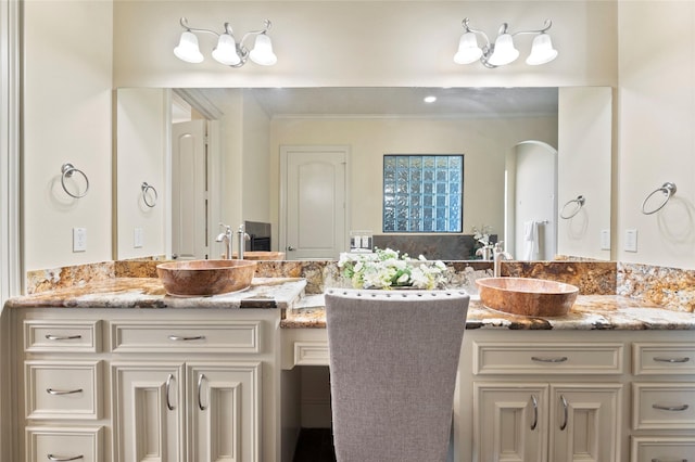 bathroom featuring vanity and ornamental molding