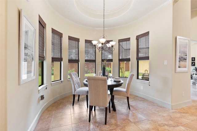 tiled dining space featuring crown molding, a notable chandelier, and a tray ceiling