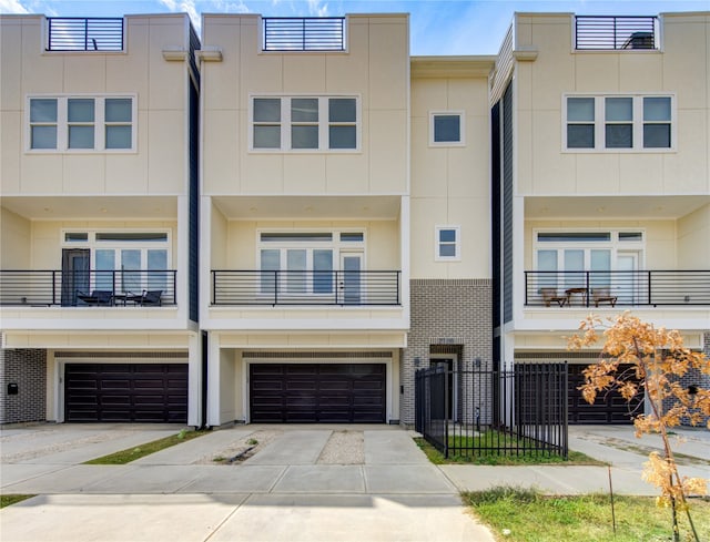 multi unit property with a balcony and a garage