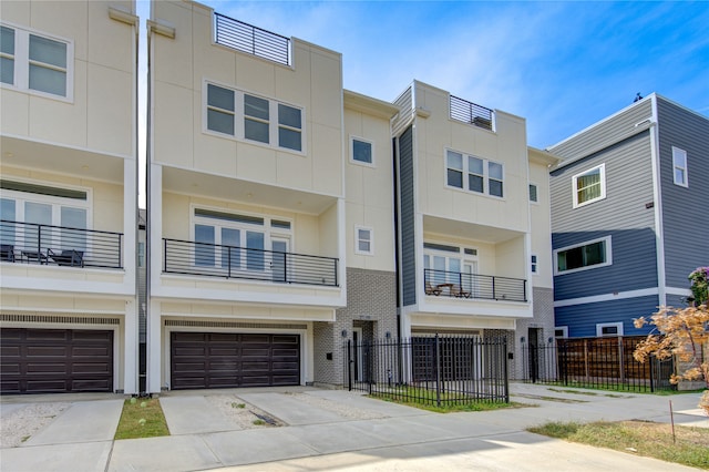 view of property with a balcony and a garage