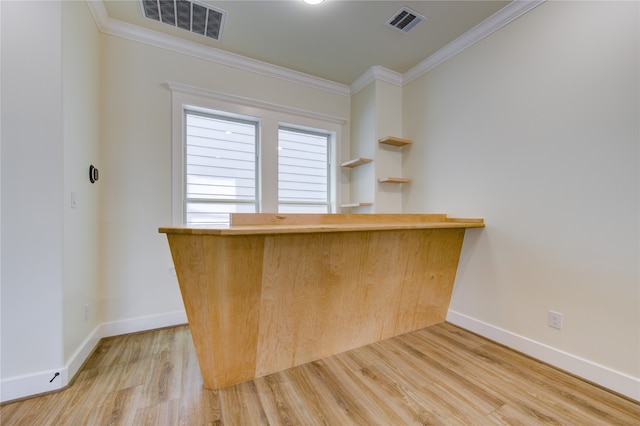 bar with light hardwood / wood-style flooring and ornamental molding