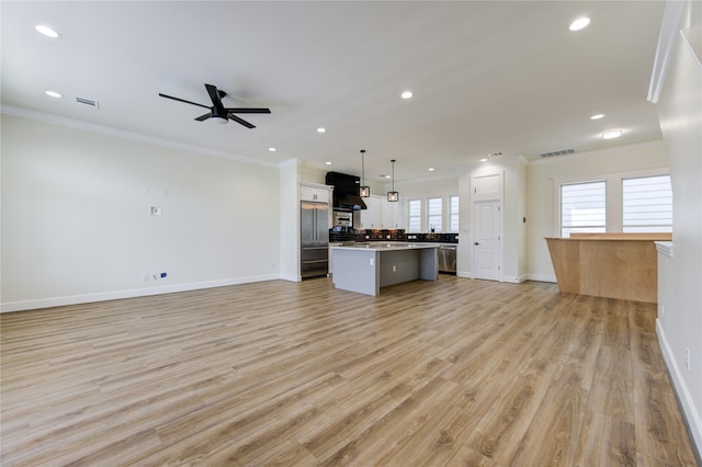 unfurnished living room with ceiling fan, light hardwood / wood-style flooring, and crown molding