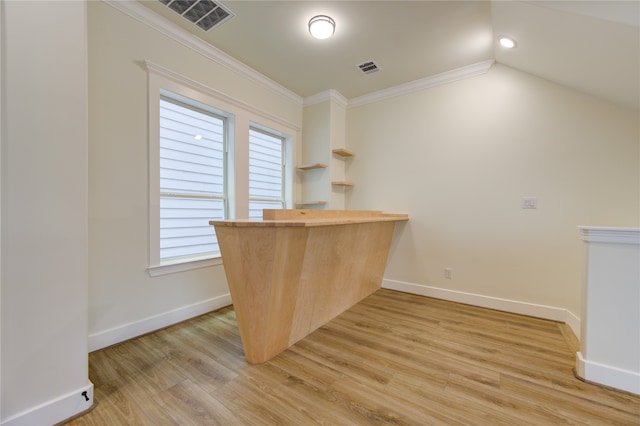 unfurnished office featuring light hardwood / wood-style flooring, a wealth of natural light, and crown molding