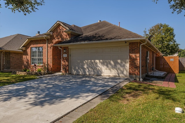 ranch-style home featuring a front lawn and a garage