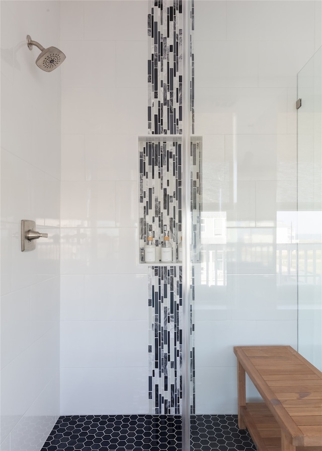 bathroom with tile walls and tiled shower