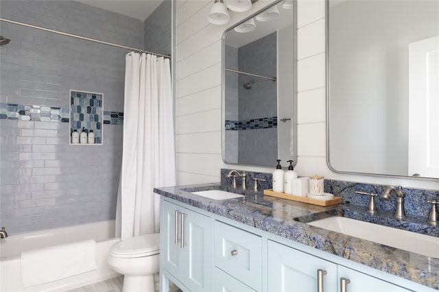 full bathroom with vanity, shower / tub combo, and toilet