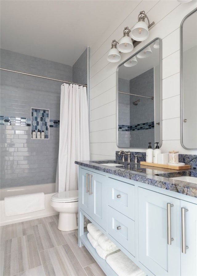 bathroom featuring vanity, wooden walls, toilet, and a shower with shower curtain