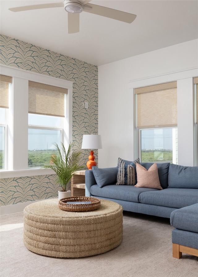 living room with ceiling fan, plenty of natural light, and carpet floors