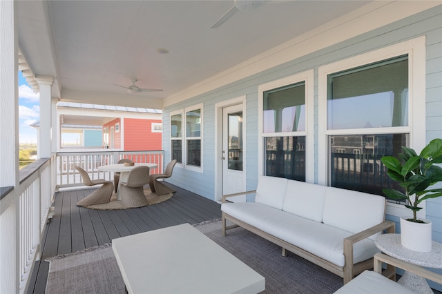 wooden terrace featuring ceiling fan and outdoor lounge area