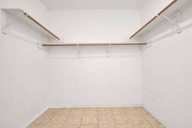 spacious closet with light tile patterned floors