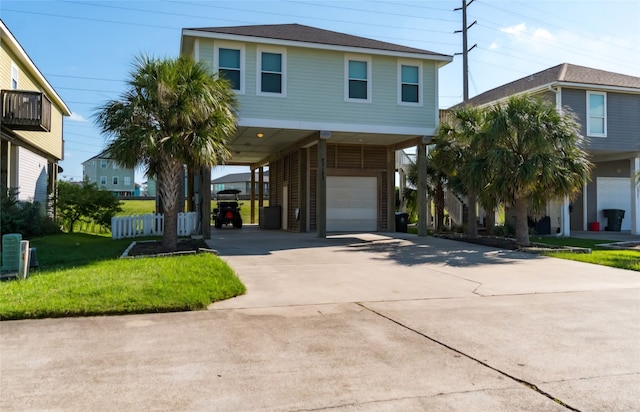 beach home with a front lawn, a carport, and a garage