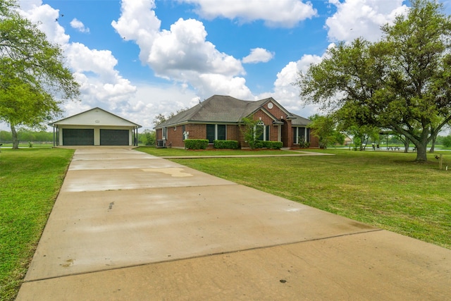 view of front of property featuring a garage, an outdoor structure, and a front lawn