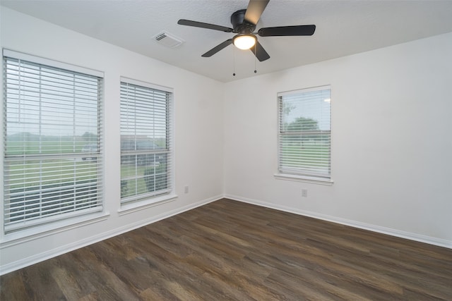 unfurnished room with ceiling fan, dark hardwood / wood-style floors, and a textured ceiling