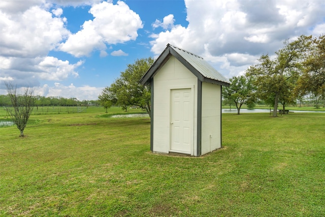 view of outdoor structure featuring a lawn