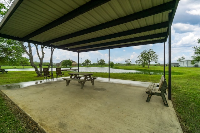 view of property's community featuring a lawn and a water view