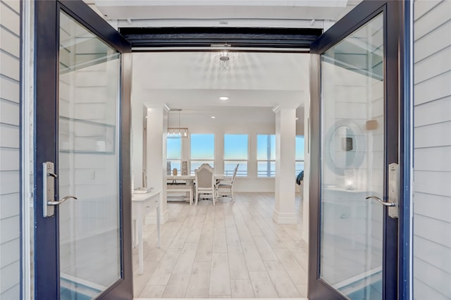 interior space featuring light hardwood / wood-style floors and ornate columns