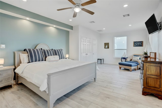 bedroom featuring light wood-type flooring, a closet, and ceiling fan