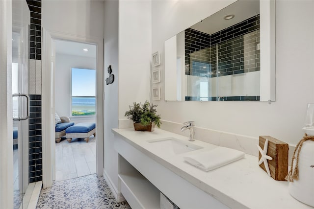 bathroom with tile patterned flooring, vanity, and an enclosed shower