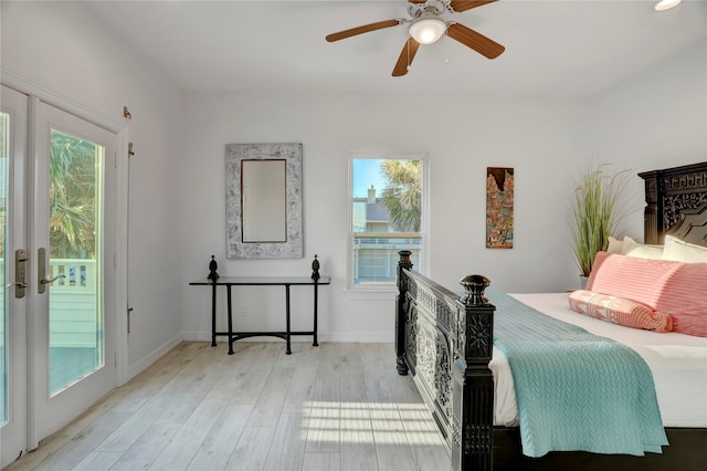 bedroom featuring multiple windows, access to outside, light hardwood / wood-style floors, and ceiling fan