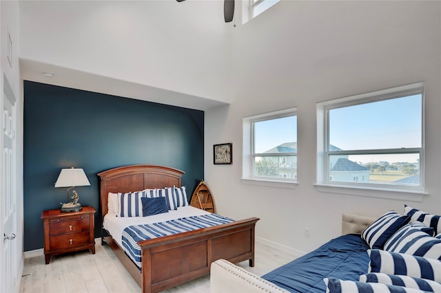 bedroom with light wood-type flooring and ceiling fan