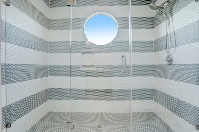 bathroom with a shower with shower door