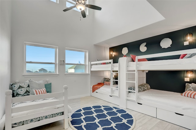 bedroom with ceiling fan and hardwood / wood-style flooring