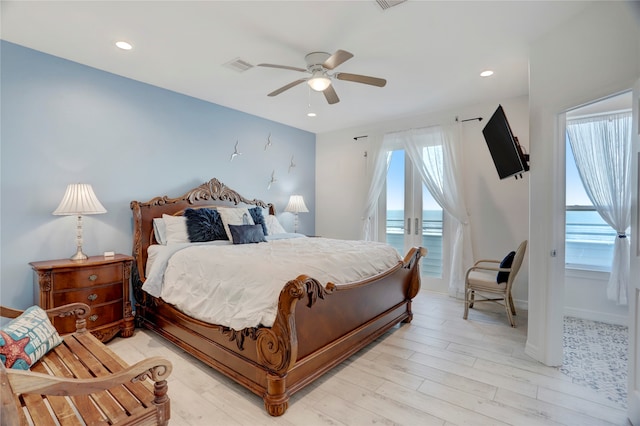 bedroom featuring multiple windows, light wood-type flooring, ceiling fan, and access to exterior