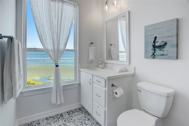 bathroom featuring vanity, toilet, and plenty of natural light