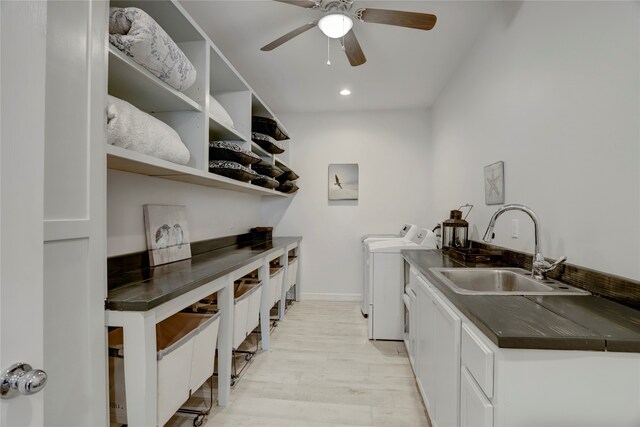 kitchen with washing machine and dryer, light hardwood / wood-style floors, white cabinetry, and ceiling fan