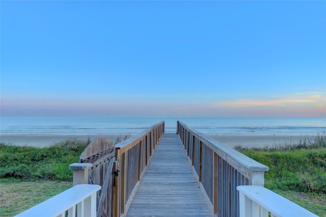 view of property's community with a beach view and a water view