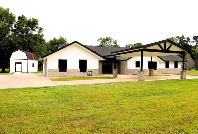 view of front of home with a front lawn and a shed