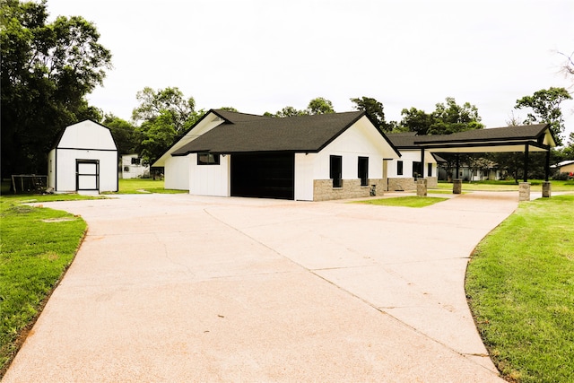 modern inspired farmhouse with a storage shed and a front lawn