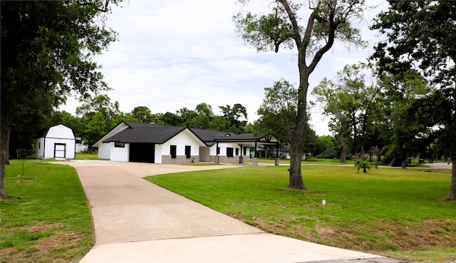 view of front of home with a storage unit and a front lawn