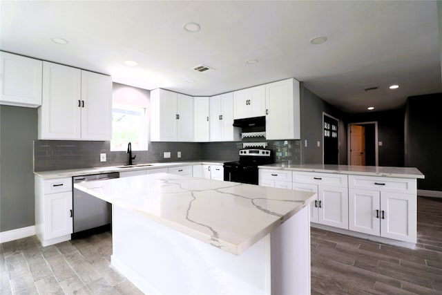 kitchen with stainless steel appliances, hardwood / wood-style flooring, a center island, and white cabinetry