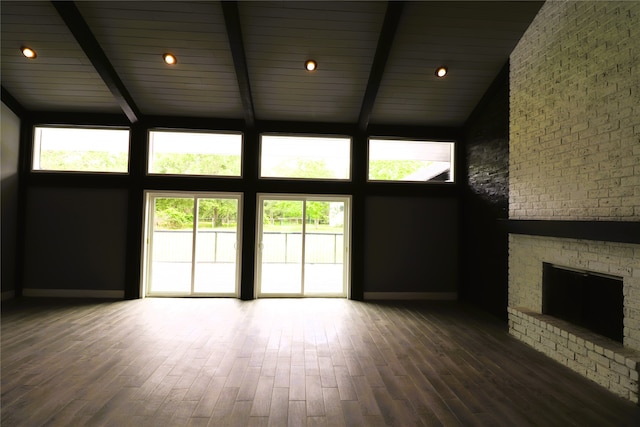 unfurnished living room featuring high vaulted ceiling, a wealth of natural light, and hardwood / wood-style floors