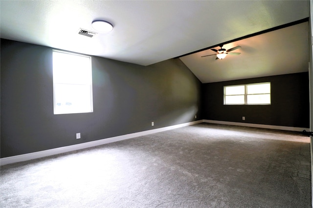 spare room featuring ceiling fan, carpet floors, and lofted ceiling