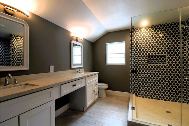 bathroom featuring walk in shower, toilet, hardwood / wood-style floors, lofted ceiling, and vanity