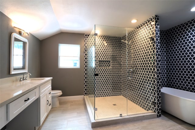 full bathroom with toilet, vaulted ceiling, separate shower and tub, hardwood / wood-style flooring, and vanity